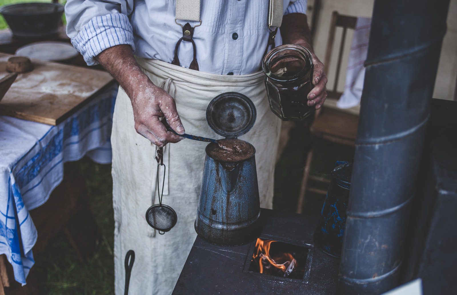 man brewing coffee on old stove